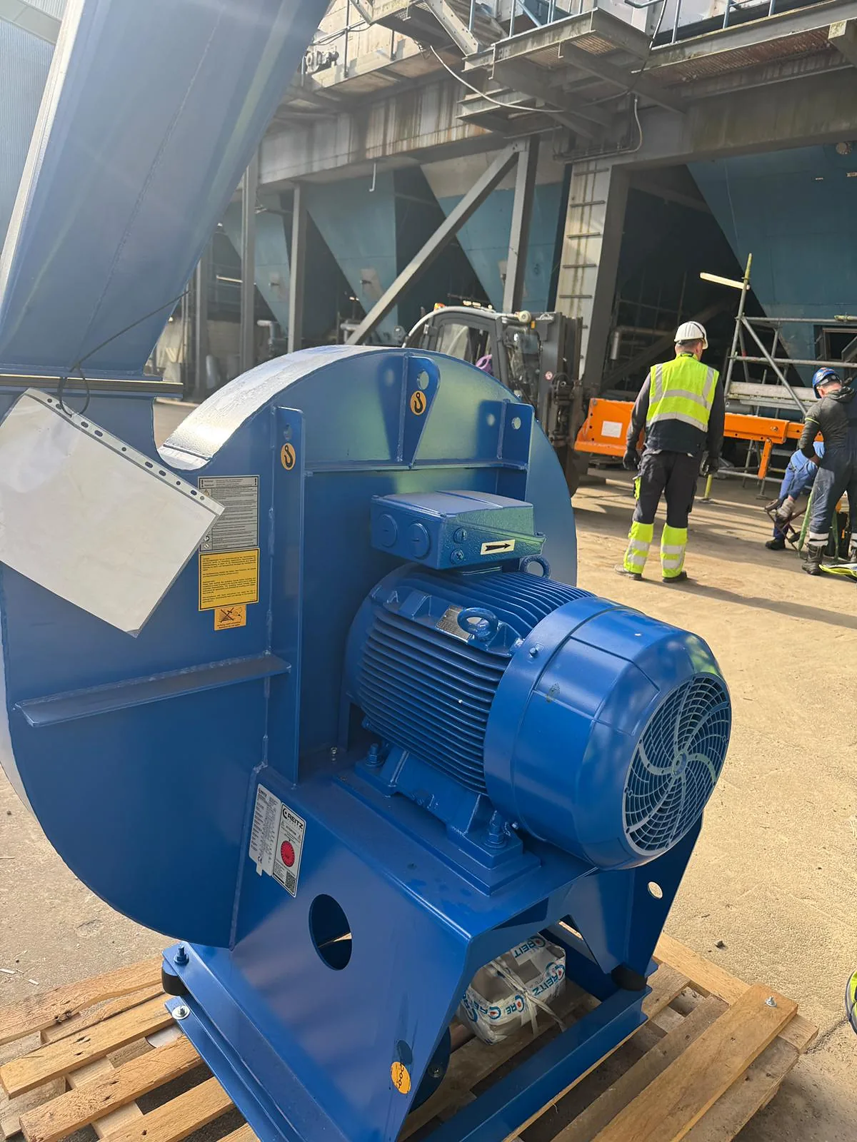 New centrifugal fan and motor on a pallet as delivered to site, before installation