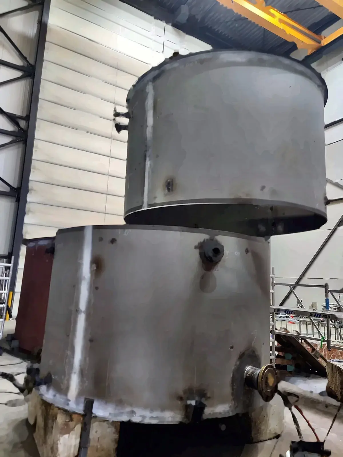 Vessel shell course being lowered onto the course below by overhead crane, with the nozzles already welded in