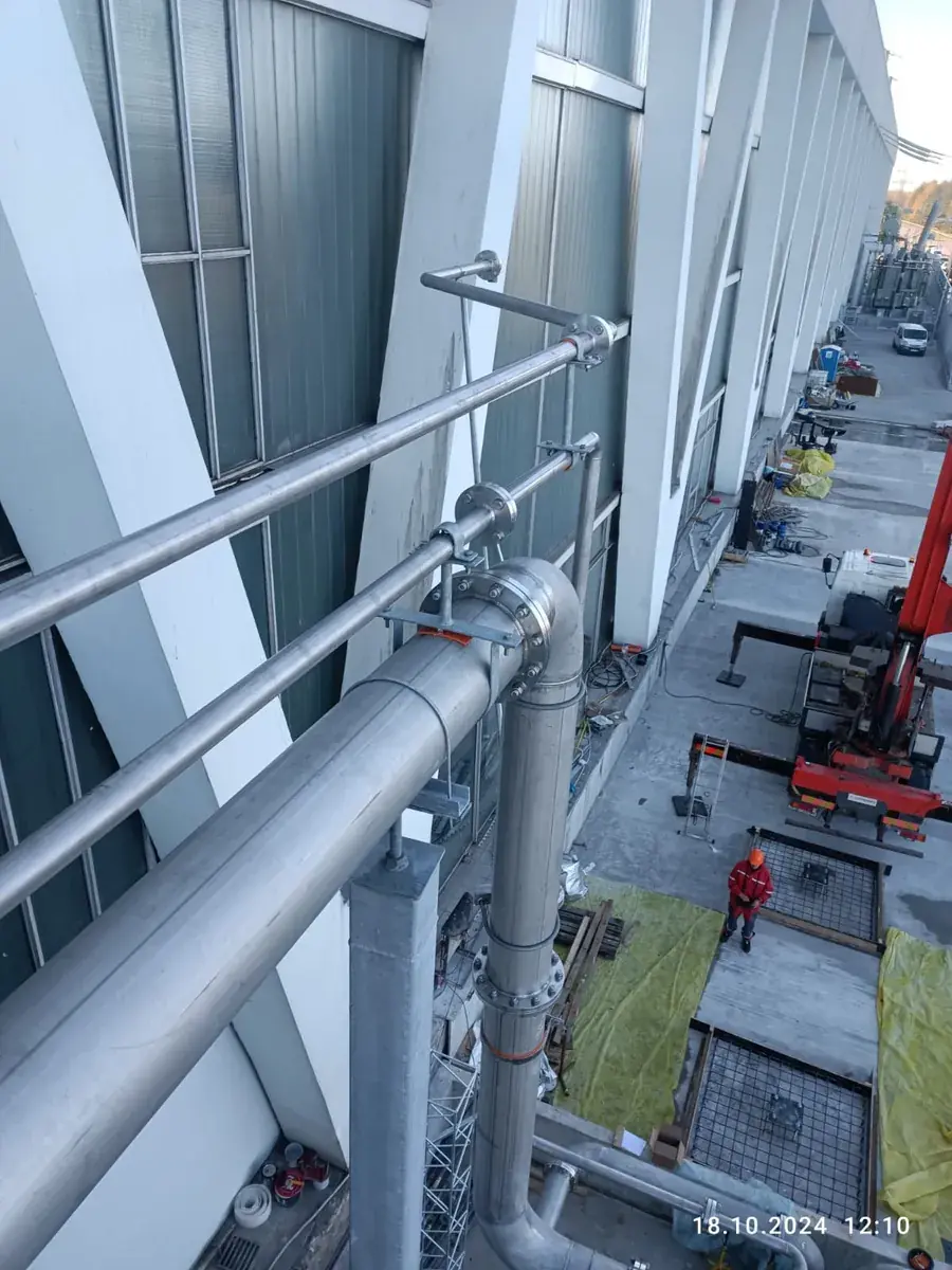 Pipe runs erected along a plant facade